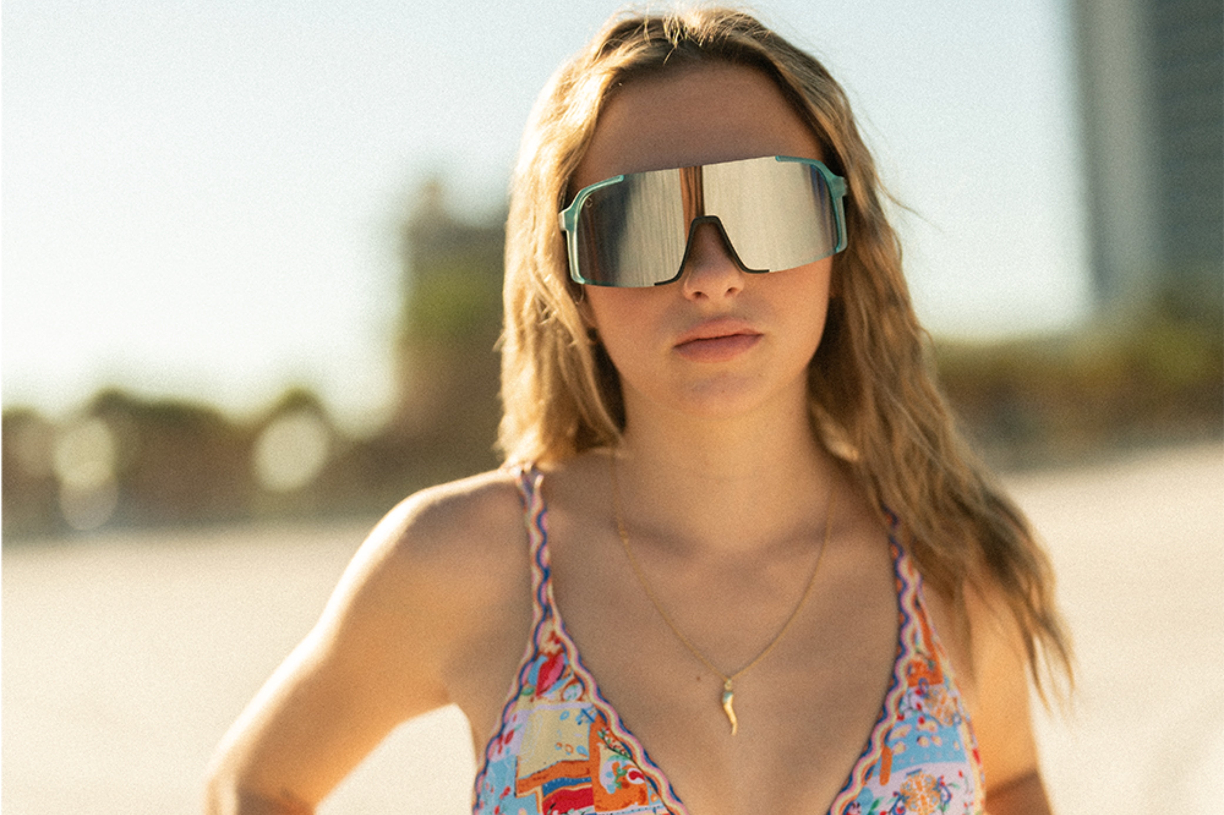 Attractive woman showcasing Wave Rider sunglasses - Fashionable eyewear for a stylish and alluring look